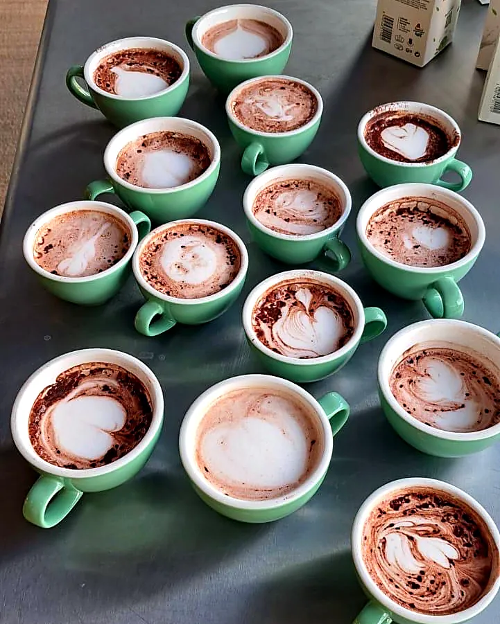 A table of latte art cups from above